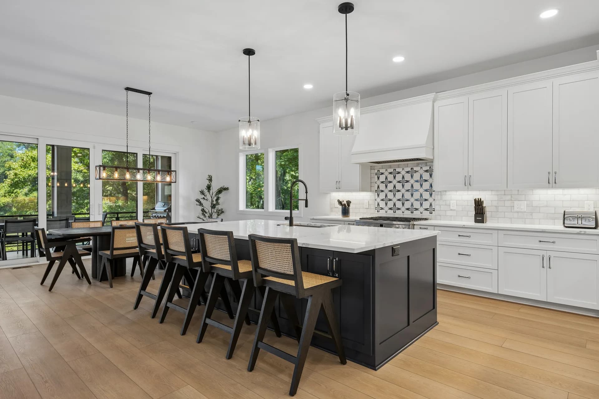 Main kitchen with island seating and dining beyond at 16 Indigo Lane