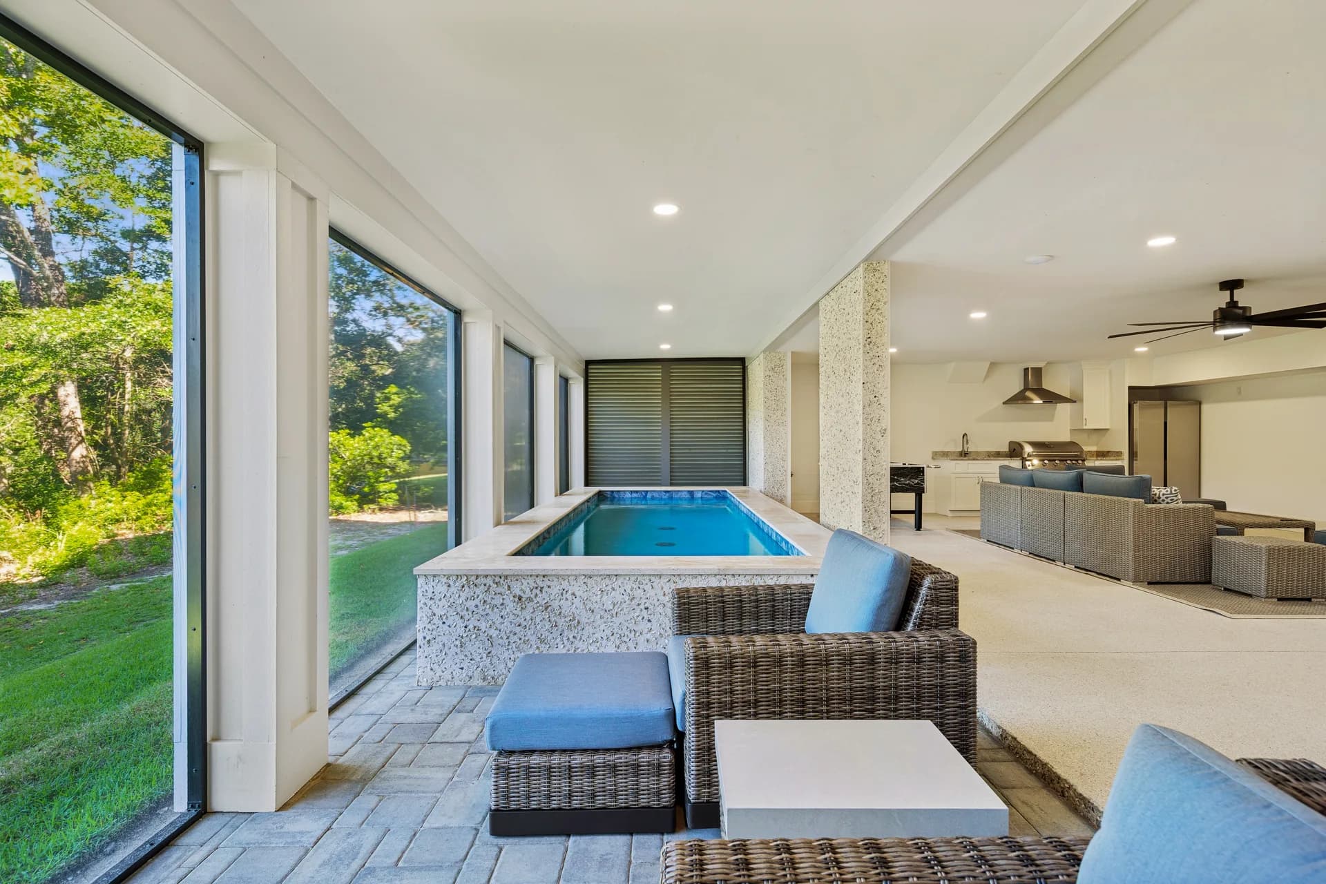 Pool with blue seating and covered cabana beyond at 16 Indigo Lane