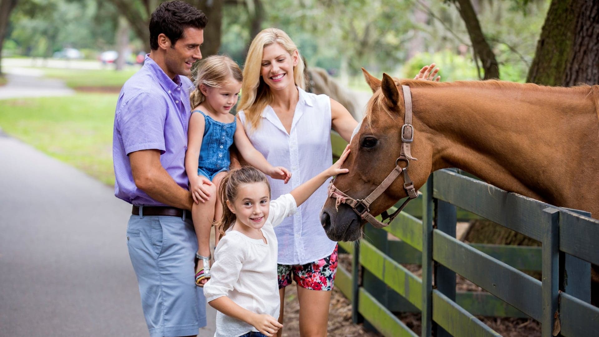A family visiting a horse at Lawton Stables in Sea Pines