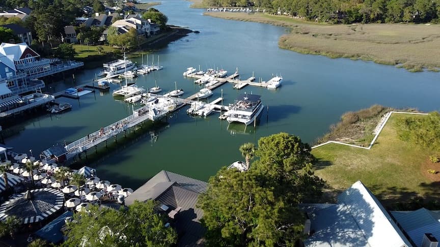 Aerial view of South Beach Marina, its docks, boats, and surrounding marsh